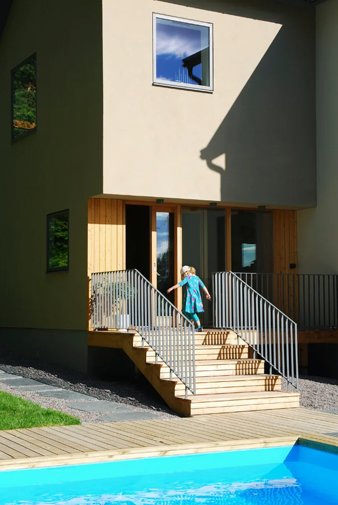 Entré med trätrappa och fasaddetaljer